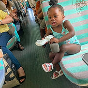Anaya participe au concours pour gagner de l'argent avec cette photo : toddler, child, bus, seat, toy, people, woman, child_sleeping, hair_puff, footwear, casual_clothing, public_transport, window, leg, hand, floor, bag, interaction, indoor, portrait