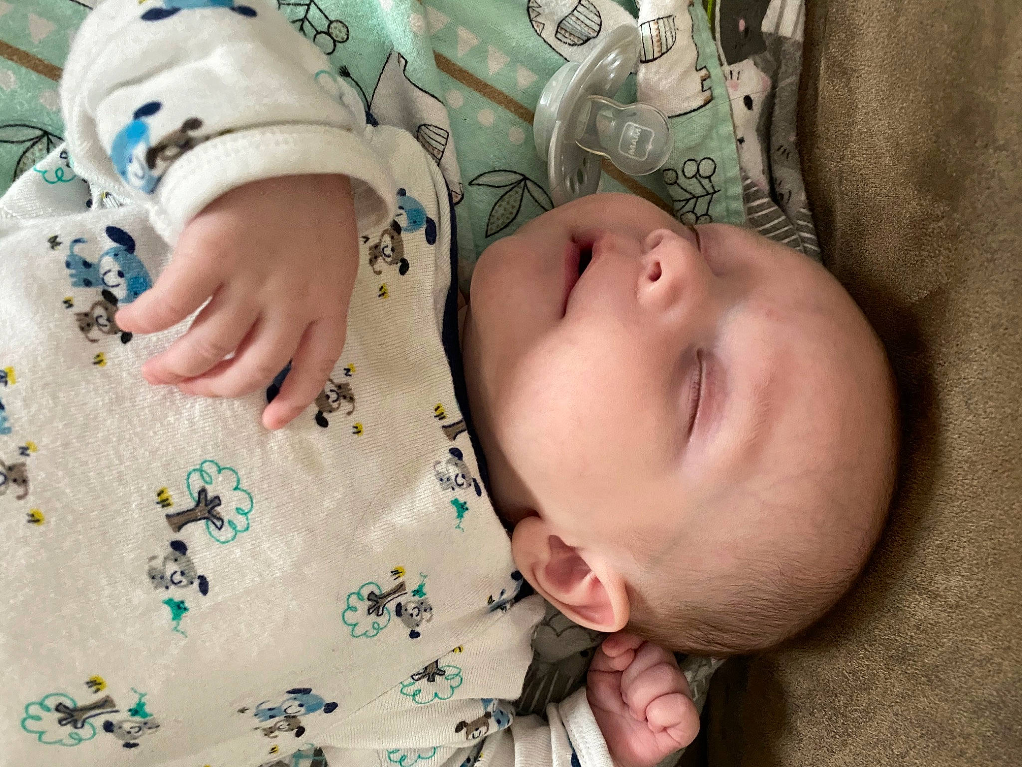 Timmy is registered to the contest to win money with this photo: arm, baby, baby_toddler_clothing, cheek, comfort, eye, eyelash, face, finger, hand, head, human_body, iris, nose, person, product, skin, sleeve, textile, toddler