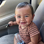 Laakea Carvalio is registered to the contest to win money with this photo: baby, child, smiling, car_seat, water_bottle, snack, striped_shirt, happy, cute, face, person, indoors, seat, arm, hand, hair, skin, mouth, teeth, eyes