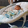 baby, sleeping, infant, baby_rocker, pajamas, indoor, soft_toys, blanket, cozy, peaceful, child, face, footwear, comfort, rest, furniture, home, cute, person, sleep