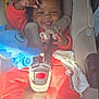 Demari joined the competition — help win amazing prizes! baby, blanket, blue_toy, car_seat, child, cute, happy, indoors, infant, pacifier, playful, plush_toy, portrait, red_clothing, safety_harness, seat_belt, smiling, sunlight, toddler, white_socks