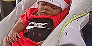 Demari joined the competition — help win amazing prizes! baby, sleeping, red_clothing, nike, hat, socks, baby_rocker, indoor, home, child, infant, cute, resting, comfort, toddler, furniture, soft_toy, carpet, peaceful, portrait