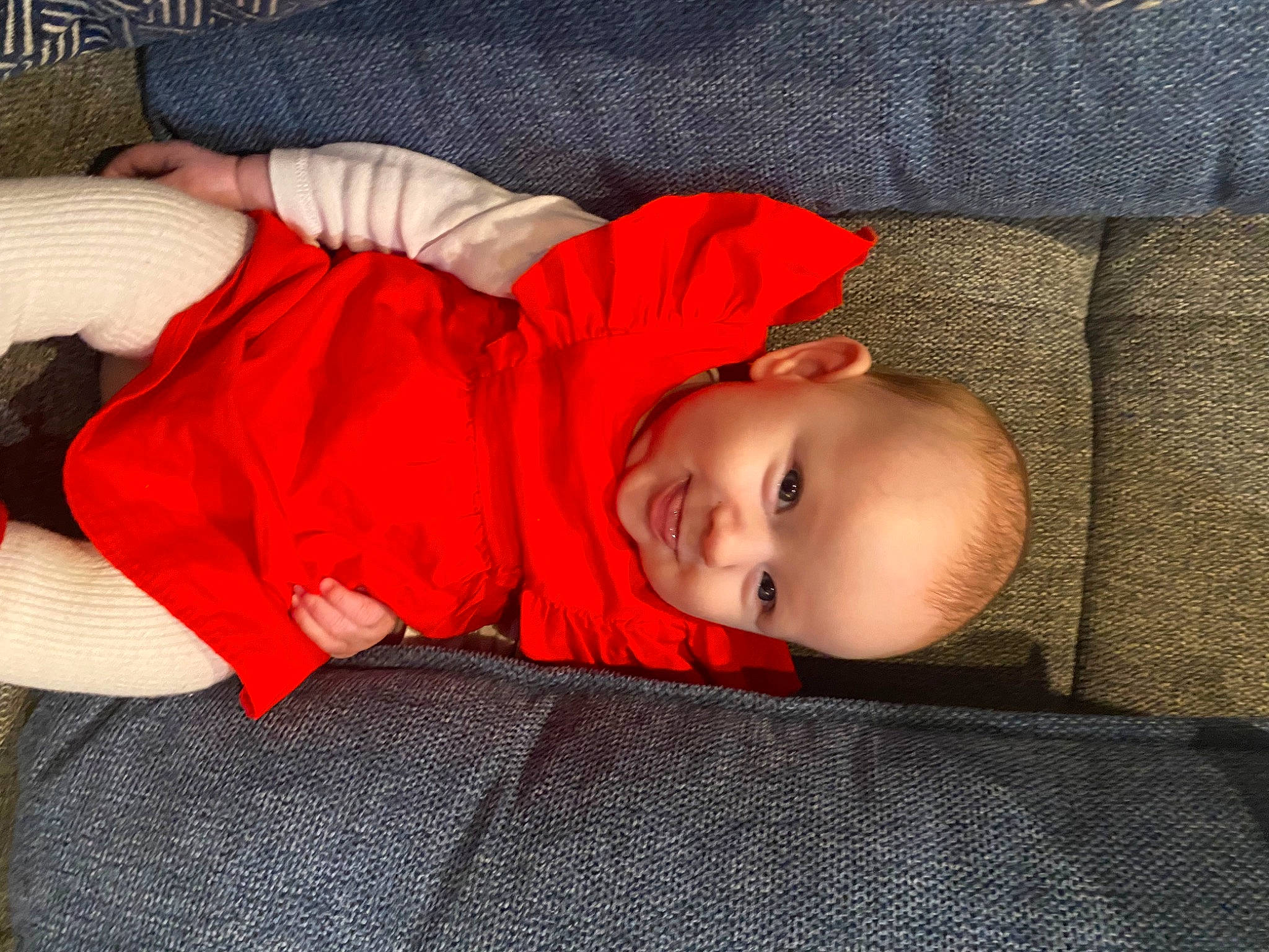 Emilia participe au concours pour gagner de l'argent avec cette photo : baby, baby_toddler_clothing, carmine, child, comfort, flooring, fun, hardwood, hat, human_leg, joy, lap, orange, pattern, person, red, room, sitting, smile, toddler