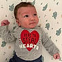 Oliver joined the competition — help win amazing prizes! baby, infant, child, face, clothing, heart, text_on_clothing, patterned_blanket, elephant_pattern, lying_down, curious_expression, grey_shirt, red_heart, blue_pants, small_hands, soft_lighting, indoors, portrait, cute, smiling