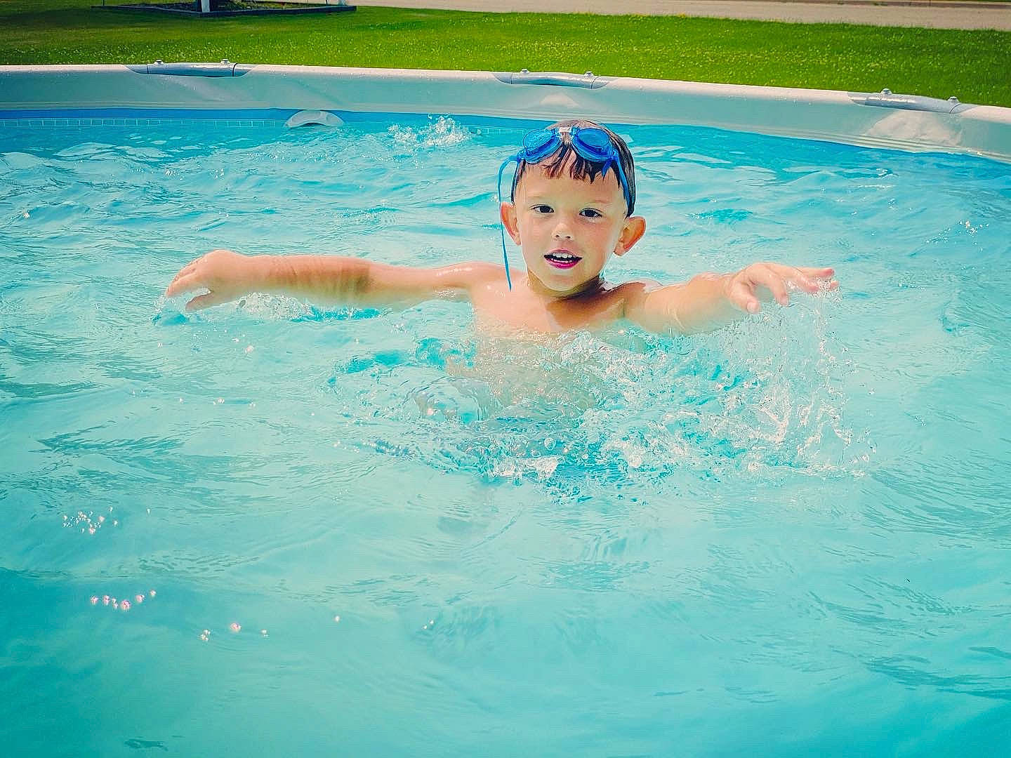 Oliver is registered to the contest to win money with this photo: aqua, bathing, blue, chest, electric_blue, eye, fluid, fun, games, happy, headgear, headwear, leisure, liquid, person, personal_protective_equipment, play, recreation, sports, swimmer