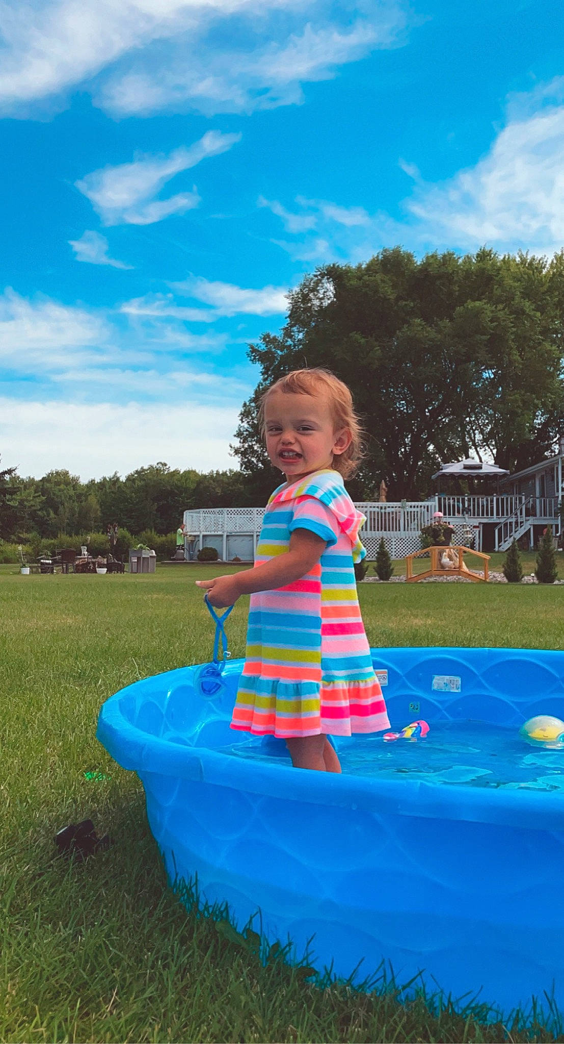 Macie is registered to the contest to win money with this photo: baby_toddler_clothing, blue, city, cloud, dress, electric_blue, event, fun, grass, happy, leisure, people_in_nature, person, plant, recreation, sky, smile, summer, toddler, tree