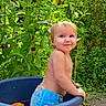 Meadow is registered to the contest to win money with this photo: toddler, child, baby, smiling, outdoor, garden, flowers, pink_flowers, plants, greenery, water_tub, plastic_container, swim_diaper, bare_chested, backyard, sunlight, portrait, standing, happy, nature