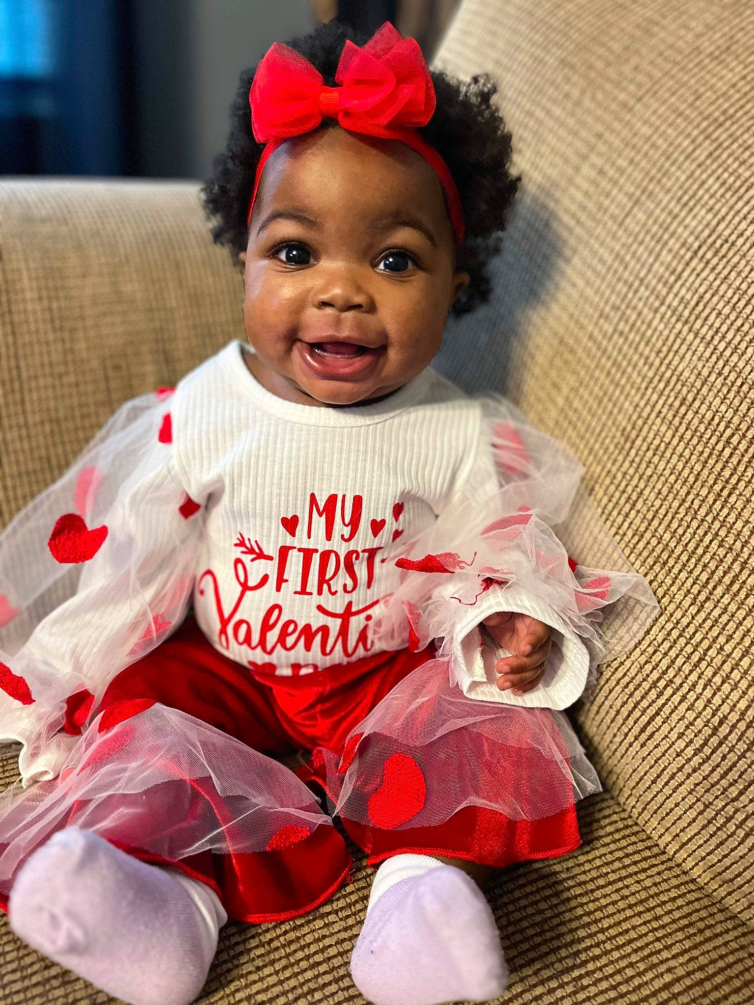 Kylah is registered to the contest to win money with this photo: baby, baby_toddler_clothing, child, costume_hat, fashion_accessory, hairstyle, happy, hat, headband, headgear, outerwear, pattern, person, pink, red, sitting, sleeve, smile, sock, t_shirt