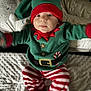 Elio a rejoint le concours — aidez-le/la à gagner de superbes lots ! baby, beanie, bonnet, cap, clothing, costume, couch, face, furniture, glove, hat, head, hood, hoodie, knitwear, person, photography, portrait, sweater, sweatshirt