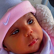 Jamya is registered to the contest to win money with this photo: baby, child, close_up, clothing, cozy, cute, expression, face, hat, headwear, infant, looking_away, newborn, outdoor, pink, portrait, skin, soft_texture, warm, white