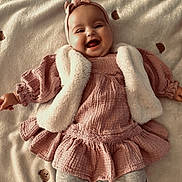 Giulia participe au concours pour gagner de l'argent avec cette photo : baby, smiling, infant, pink_dress, headband, blanket, bear_pattern, happy, child, cute, soft_texture, vest, tights, leopard_print, lying_down, portrait, indoors, cozy, warm_clothing, adorable