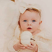 Ayla is registered to the contest to win money with this photo: baby, child, infant, blue_eyes, headband, bow, pumpkin, holding, soft_blanket, neutral_colors, cozy, portrait, cute, looking_at_camera, clothing, hands, skin, face, indoors, young