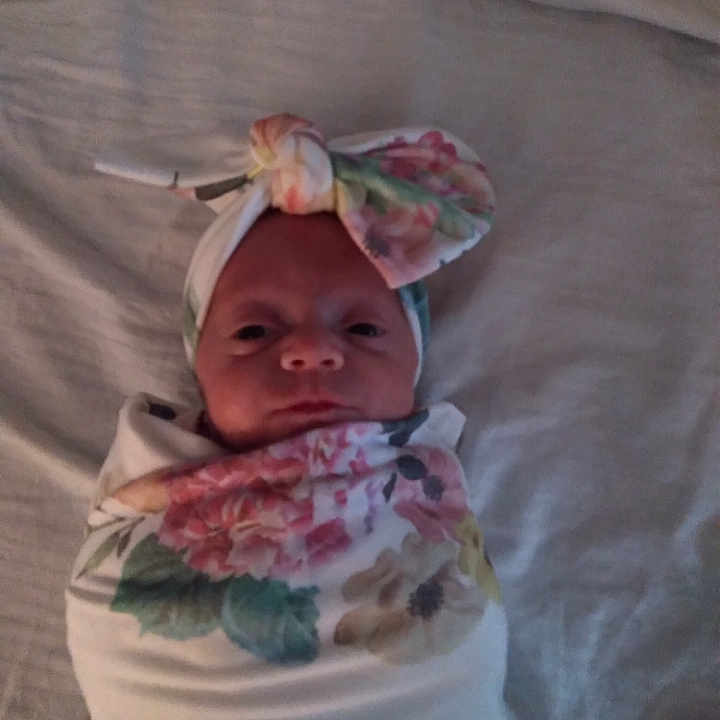 Chelsea joined the competition — help win amazing prizes! baby, baby_carriage, baby_products, baby_toddler_clothing, bonnet, child, eye, face, fashion_accessory, happy, head, linens, pattern, peach, pink, sitting, smile, sweetness, textile, toddler