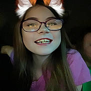 Aaliyah joined the competition — help win amazing prizes! child, girl, glasses, long_hair, smile, teeth, digital_ears, fox_ears, purple_shirt, dark_background, face, portrait, happy, young, person, indoors, closeup, head_and_shoulders, casual, fun