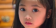 Alyna Bristol is registered to the contest to win money with this photo: black_hair, blurred_background, child, close-up, curious, drawer, expression, eyes, face, girl, hair, indoors, innocent, long_hair, person, pink_clothing, portrait, soft_lighting, warm_colors, young
