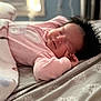 baby, sleeping, blanket, pink_pajamas, bed, bedspread, indoor, peaceful, infant, soft_light, resting, child, cozy, cute, face, hand, hair, newborn, comfort, relaxation