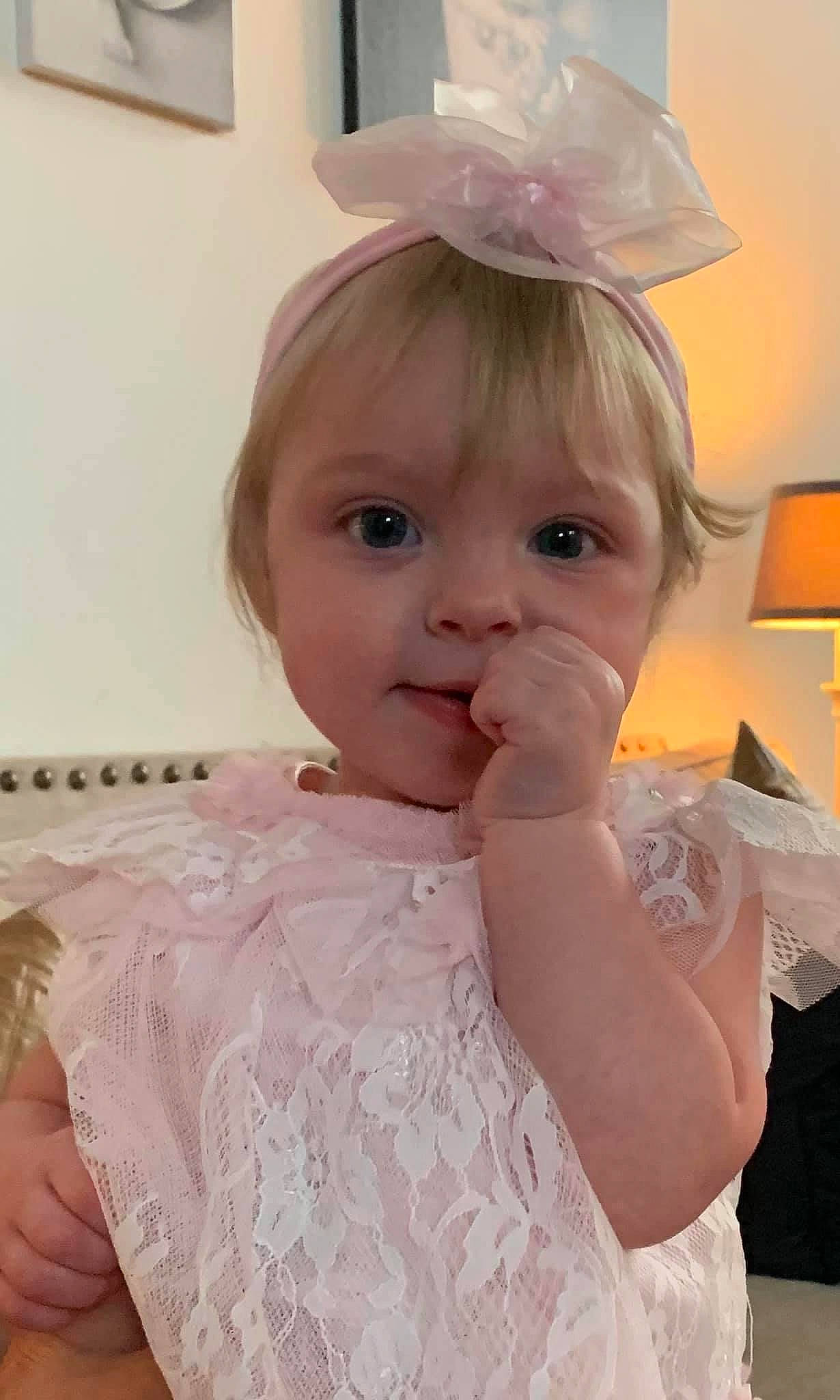 Mercedes is registered to the contest to win money with this photo: baby, baby_toddler_clothing, bridal_accessory, costume_hat, day_dress, dress, eyelash, face, happy, hat, headgear, headpiece, helmet, iris, lip, person, pink, skin, sleeve, toddler