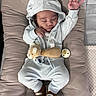 baby, sleeping, hood, plush_toy, pacifier, cushion, blue_outfit, footwear, socks, infant, peaceful, indoors, cozy, child, cute, soft_texture, relaxing, closed_eyes, hand_gesture, portrait
