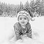 baby, infant, santa_hat, hat, snow, snowy_forest, pine_trees, forest, winter, crawling, portrait, black_and_white, monochrome, cute, smile, outdoors, festive, cold, clothing, young_child