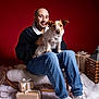Lipton participe au concours pour gagner de l'argent avec cette photo : casual_clothing, christmas, decor, dog, festive, fur_blanket, gift, holiday, indoor, jeans, lantern, man, pet, portrait, red_background, sitting, sled, smile, white_sneakers, winter