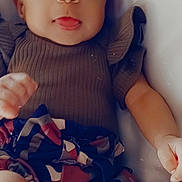 Damiana is registered to the contest to win money with this photo: baby, child, infant, portrait, smiling, happy, bow, headband, ruffled_sweater, colorful_clothing, skirt, lying_down, indoors, close_up, face, eyes, hands, legs, couch, fashion