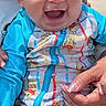 baby, blue_sleeves, child, cute, fence, hand, happy, holding, infant, joyful, laughing, onesie, outdoor, person, portrait, sitting, skin, smiling, sunlight, winnie_the_pooh