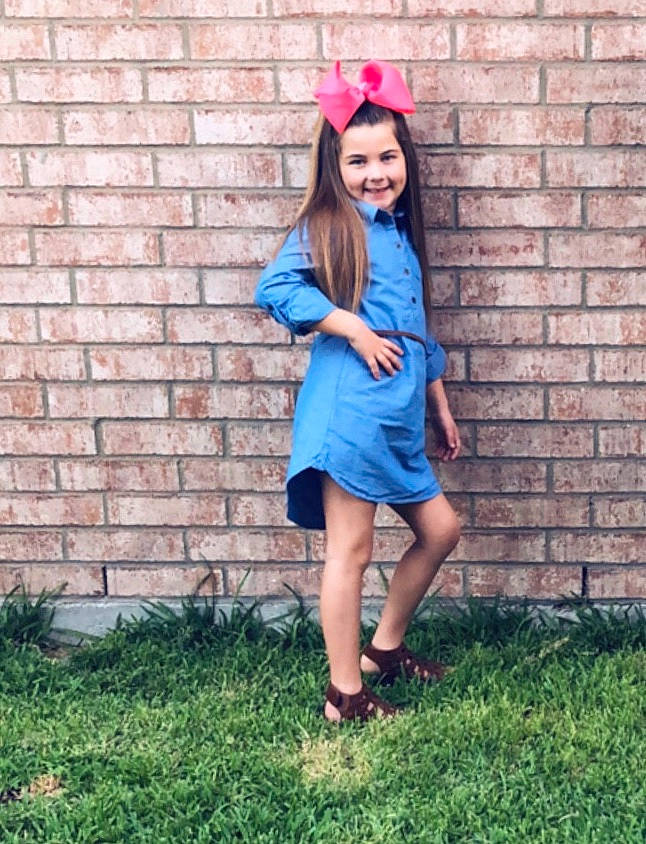 Kirra is registered to the contest to win money with this photo: abdomen, blue, cap, clothing, costume, dress, electric_blue, fun, girl, grass, headgear, joint, joy, leg, outerwear, pattern, person, pink, shorts, shoulder