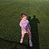 casual_clothing, child, daylight, field, girl, grass, hello_kitty, injury, knee, outdoor, people, person, photography, playing_field, shadow, shorts, sneakers, sports, sunlight, tshirt