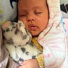 Aurora is registered to the contest to win money with this photo: baby, infant, sleeping, portrait, face, closed_eyes, blanket, swaddled, plush_toy, stuffed_animal, cuddling, hand, clothing, indoor, cozy, cute, peaceful, pink, soft, photography
