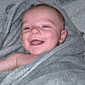 Tommy participe au concours pour gagner de l'argent avec cette photo : baby, towel, smile, happy, child, face, skin, blanket, wrapped, cute, infant, portrait, indoors, soft, cozy, head, expression, tongue, newborn, person