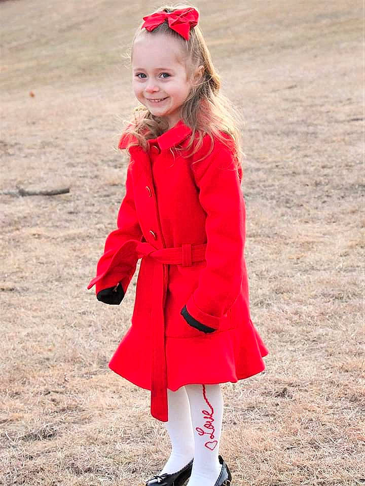 Maddilyn is registered to the contest to win money with this photo: child, child_model, clothing, coat, headgear, jacket, joy, outerwear, overcoat, person, pink, red, sleeve, smile, standing, street_fashion, tights, toddler, trench_coat