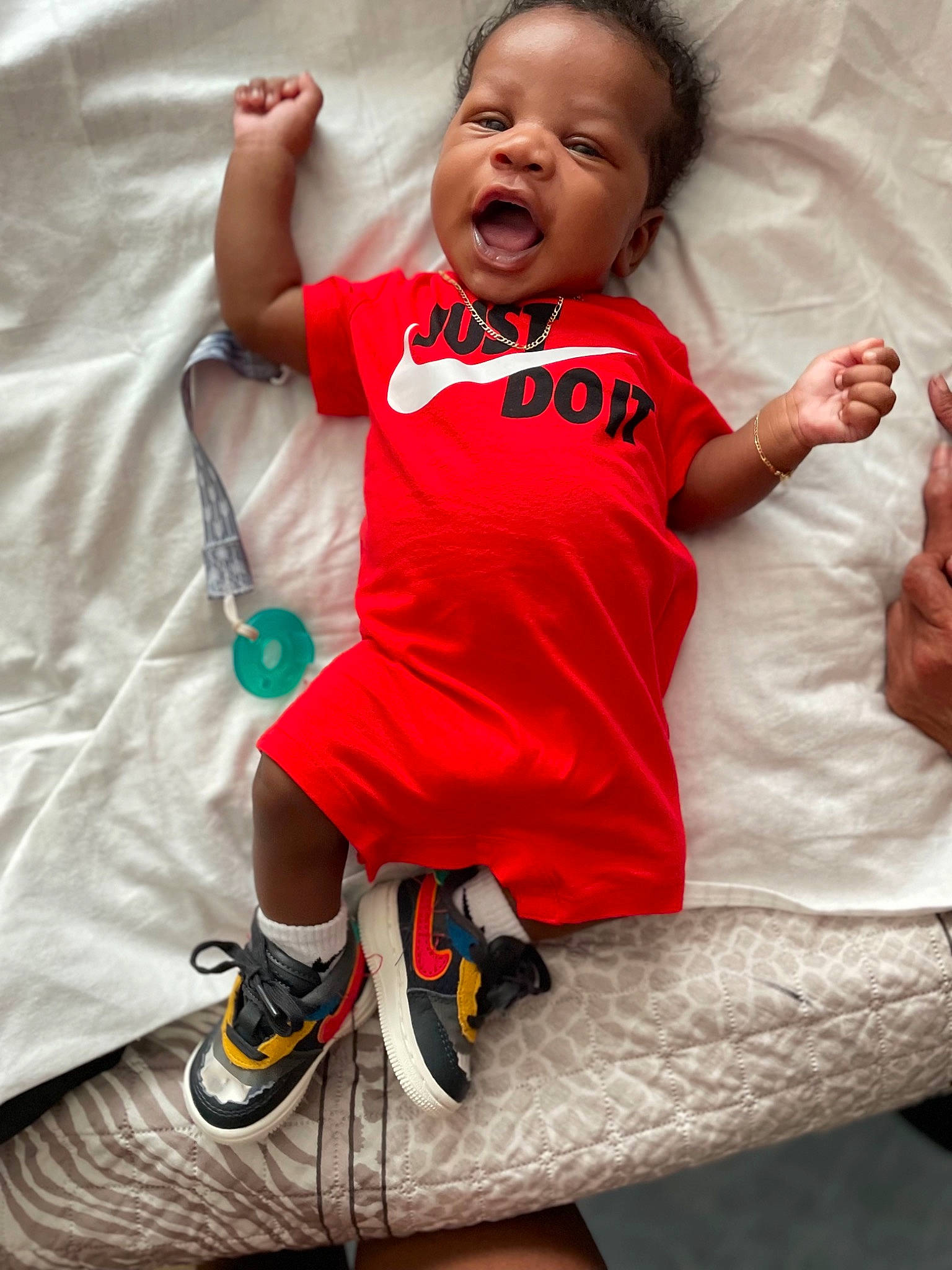 Kareem joined the competition — help win amazing prizes! baby, baby_toddler_clothing, child, comfort, eye, finger, gesture, happy, head, human_leg, knee, linens, person, pink, red, sleeve, sportswear, t_shirt, thigh, toddler