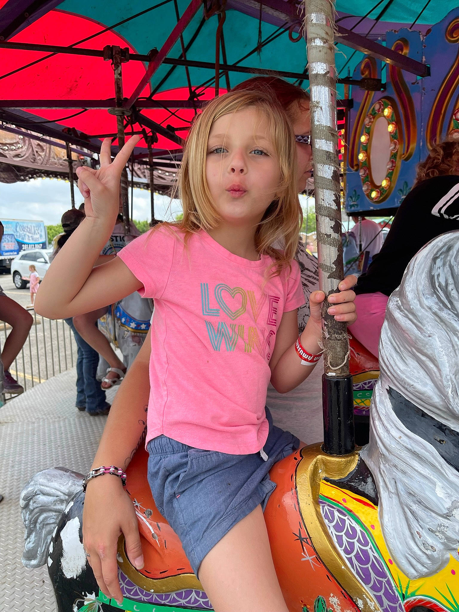 Brooklyn joined the competition — help win amazing prizes! amusement_ride, carousel, child, city, cool, event, fun, happy, human_leg, leisure, magenta, nonbuilding_structure, person, pink, public_event, recreation, shorts, t_shirt, thigh, toddler