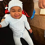 Jailmya is registered to the contest to win money with this photo: accessories, architecture, baby, bag, building, cap, clothing, couch, face, furniture, handbag, happy, hat, head, indoors, livingroom, person, photography, portrait, room