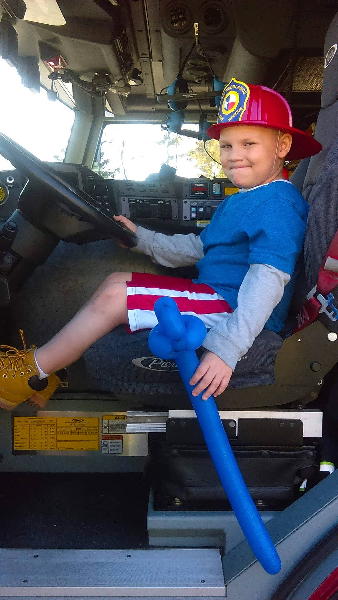 Terryn is registered to the contest to win money with this photo: auto_part, automotive_design, automotive_exterior, baseball_cap, electric_blue, family_car, fun, headwear, helmet, joy, luxury_vehicle, motor_vehicle, person, personal_protective_equipment, service, sitting, smile, steering_wheel, toddler, vehicle