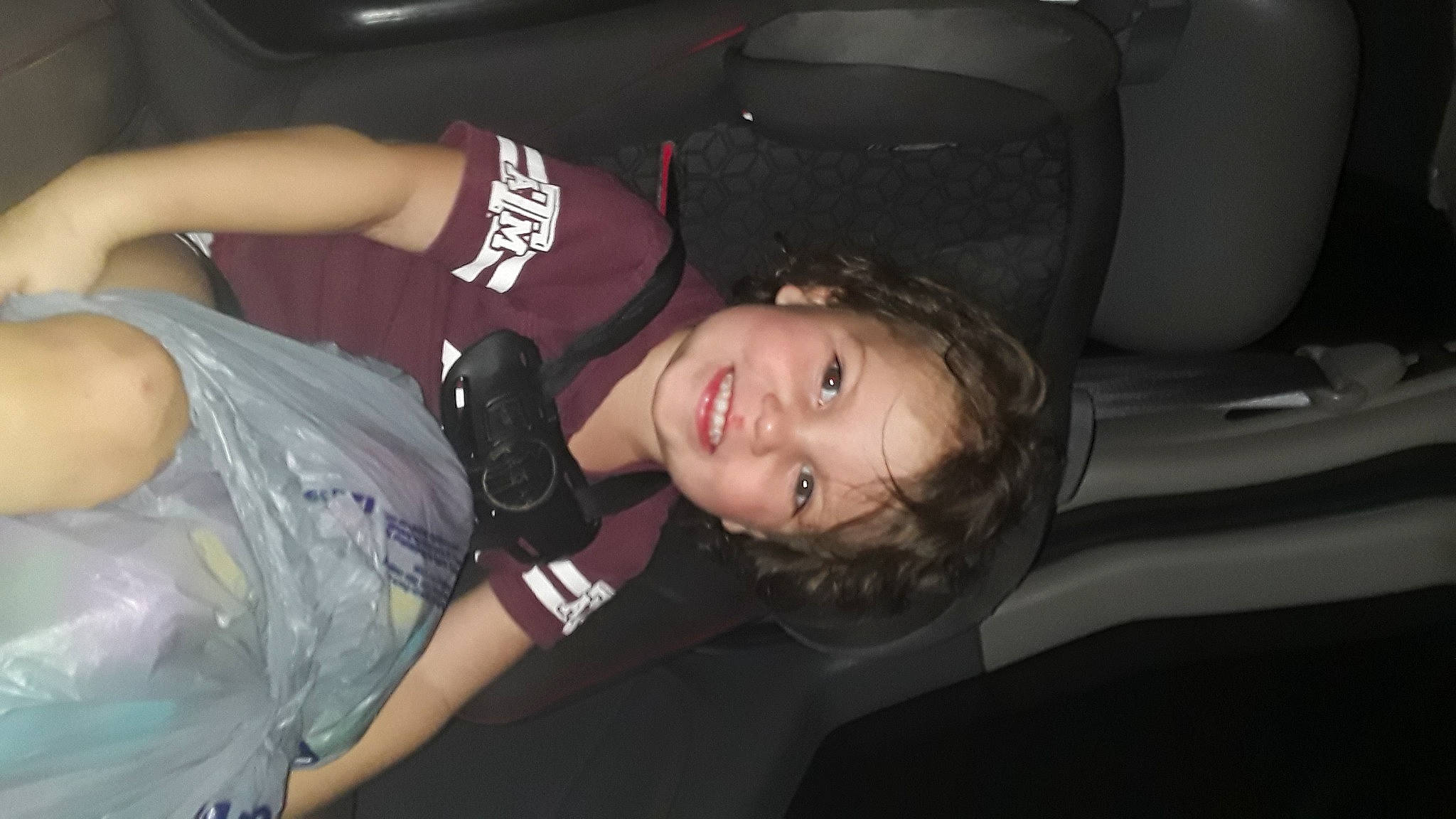 Tavin is registered to the contest to win money with this photo: auto_part, automotive_exterior, automotive_lighting, bumper, chest, darkness, elbow, event, family_car, flash_photography, fun, happy, human_leg, jewellery, joy, luxury_vehicle, midnight, person, smile, t_shirt