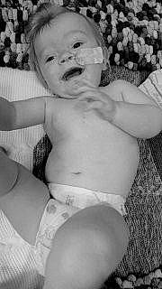 Leonidas is registered to the contest to win money with this photo: black_and_white, cheek, chest, eye, face, finger, gesture, hair, hairstyle, happy, head, human_body, iris, jaw, lip, mouth, organ, person, style, toddler