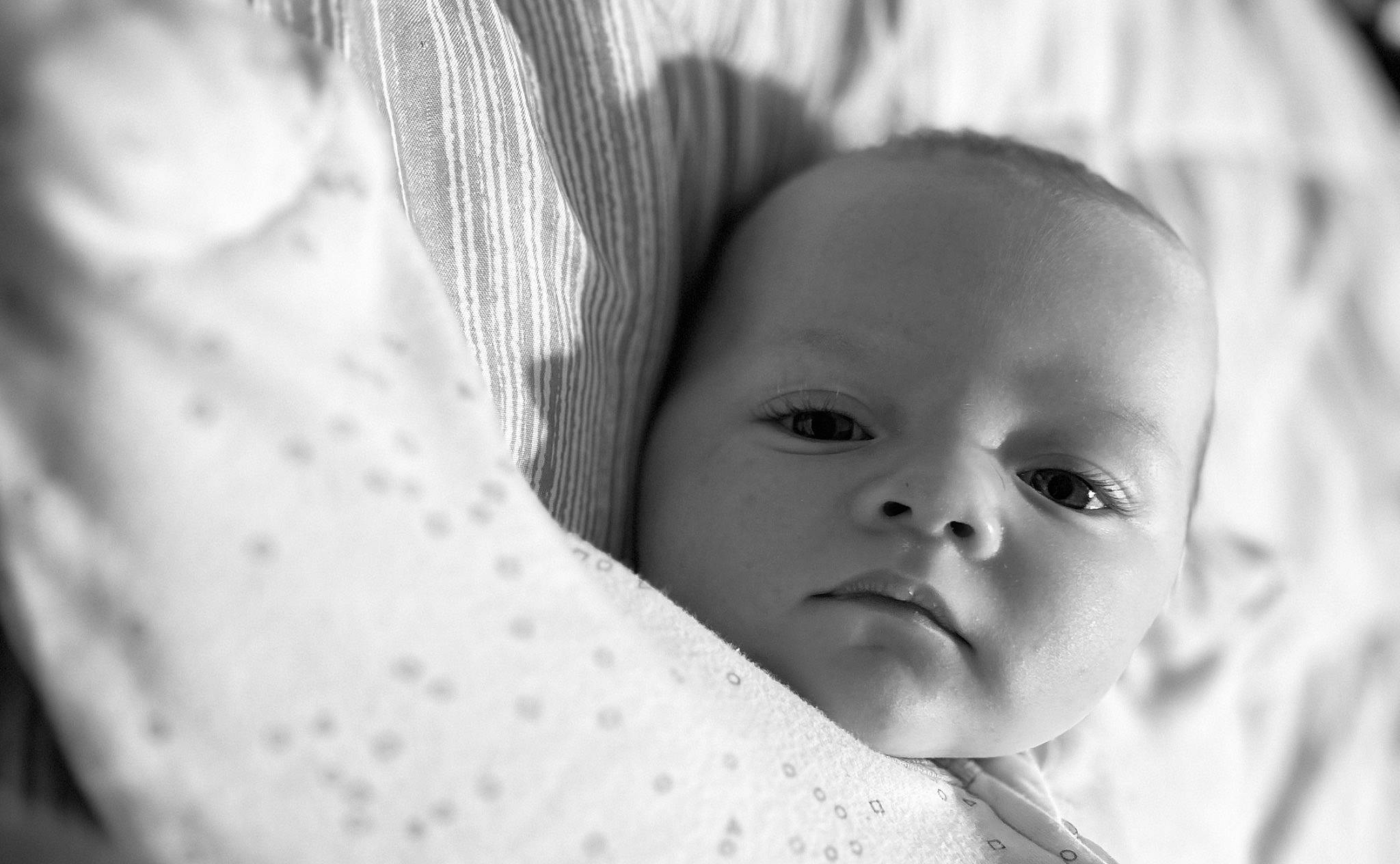 Maverick is registered to the contest to win money with this photo: baby, black_and_white, cheek, child, close_up, comfort, eye, eyebrow, eyelash, flash_photography, happy, head, iris, monochrome, monochrome_photography, nose, person, skin, smile, style