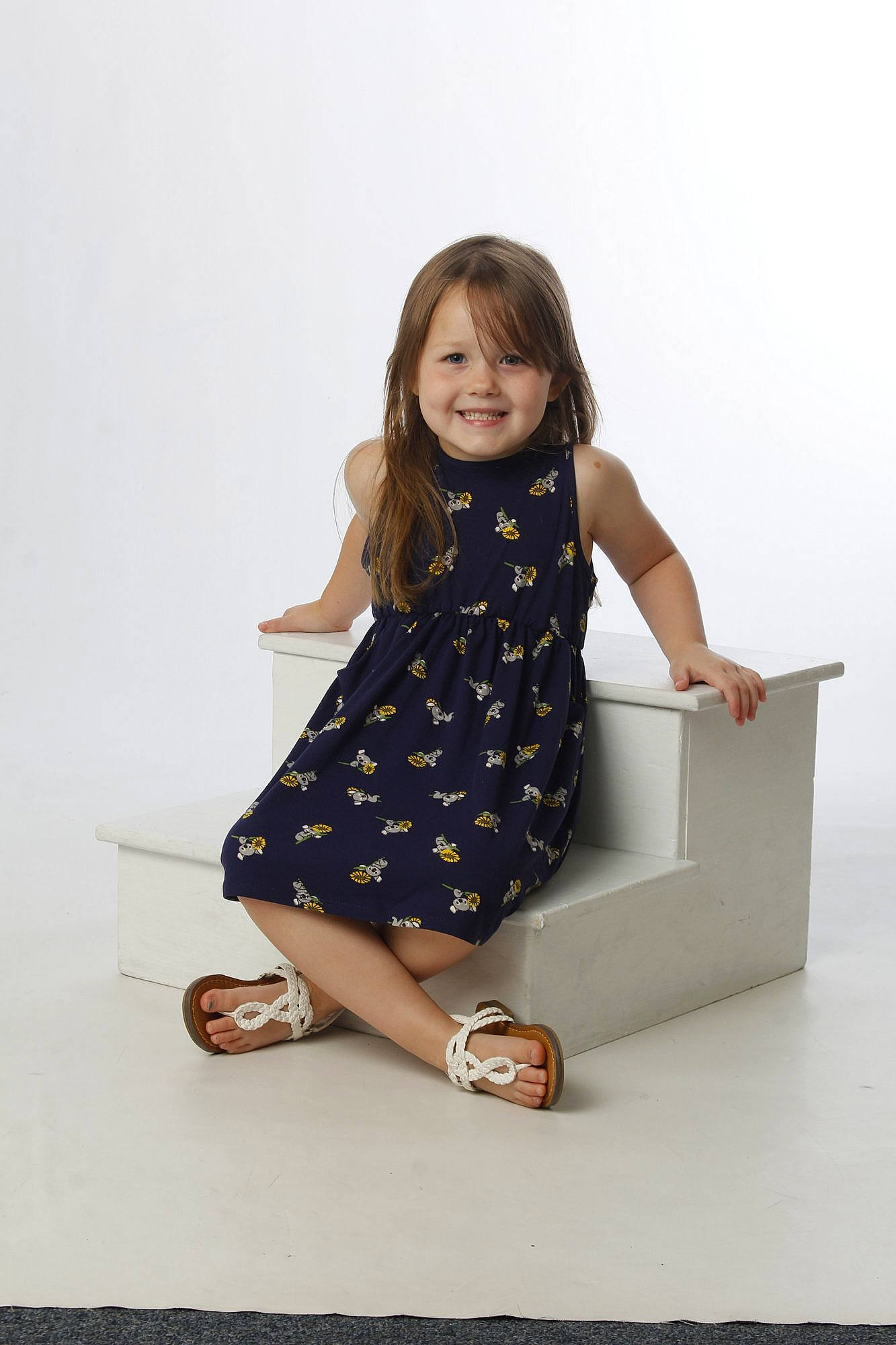 Kacee is registered to the contest to win money with this photo: child, elbow, fashion_accessory, fashion_design, flash_photography, flooring, foot, happy, human_leg, joint, joy, knee, pattern, person, sandal, sitting, sleeve, smile, sock, thigh