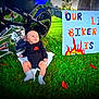 baby, infant, motorcycle, black_clothing, grass, outdoor, sign, handmade_sign, text, harley_davidson, socks, chrome, reflection, tree, person, two_months, cute, child, motorbike, greenery