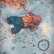 Ryker joined the competition — help win amazing prizes! baby, blanket, child, colorful_clothing, cute, denim_pants, grass, highland_cow, infant, leaves, lying_down, milestone, months, nature, numbers, one_month, outdoor, portrait, soft_light, striped_shirt
