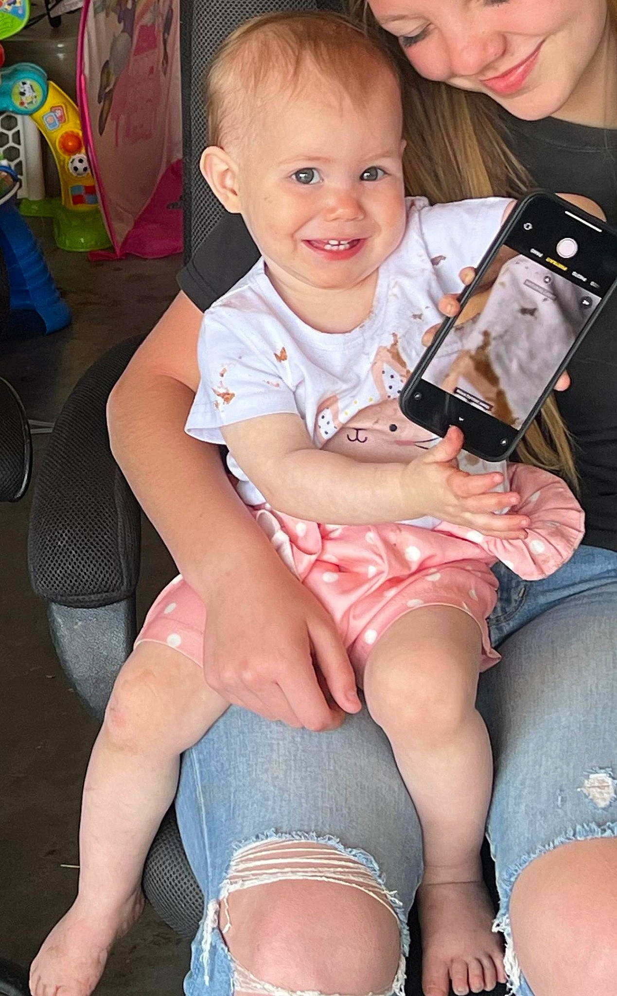 Hazel Grace is registered to the contest to win money with this photo: baby_toddler_clothing, cheek, eye, face, facial_expression, finger, hairstyle, head, human_body, iris, joy, lap, leg, mouth, muscle, organ, person, pink, skin, smile