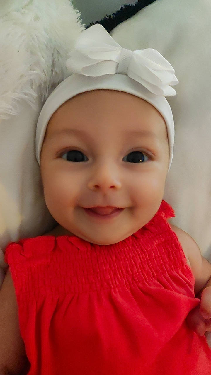 Kiara participe au concours pour gagner de l'argent avec cette photo : baby, baby_toddler_clothing, beauty, cheek, eyebrow, eyelash, facial_expression, flash_photography, happy, headgear, headwear, iris, joy, lip, person, pink, red, skin, sleeve, smile