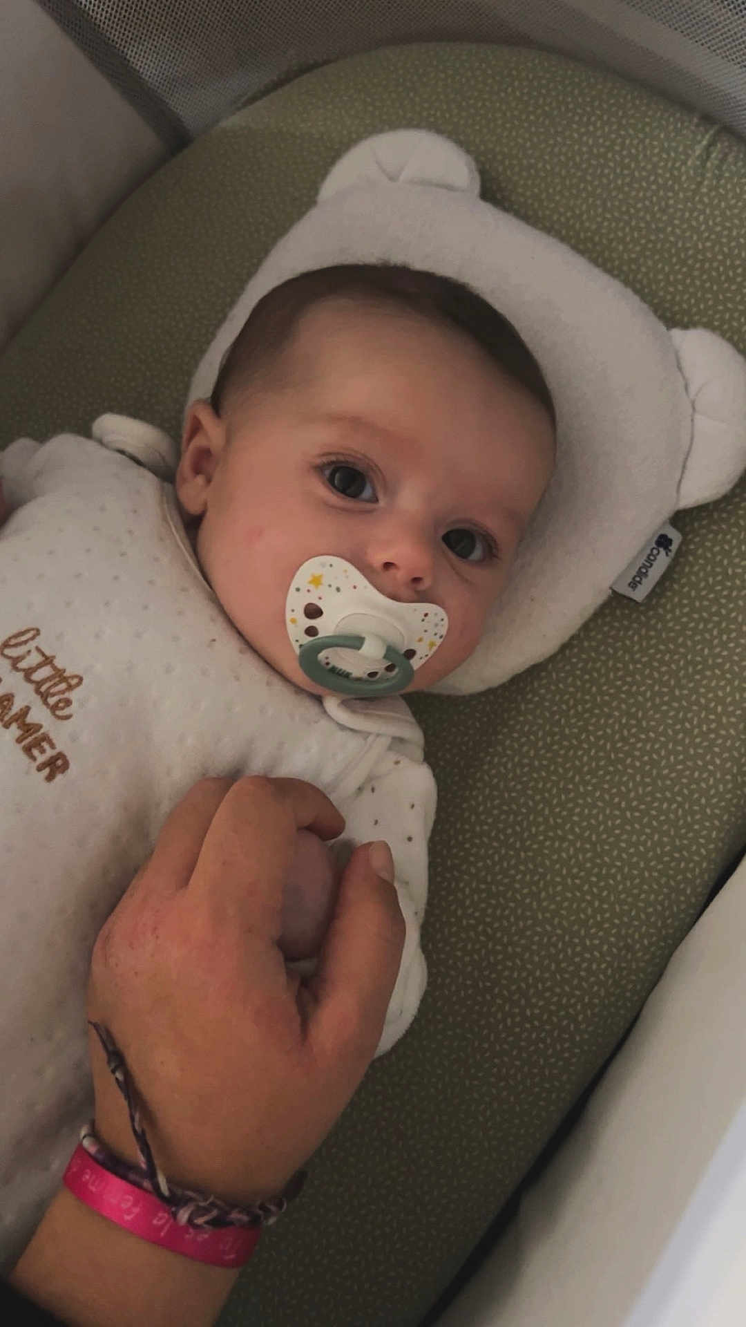 Mila participe au concours pour gagner de l'argent avec cette photo : baby, pacifier, hand, cushion, infant, sleepwear, resting, cute, child, holding_hand, soft, patterned, face, portrait, closeup, indoor, comfort, peaceful, newborn, sleep