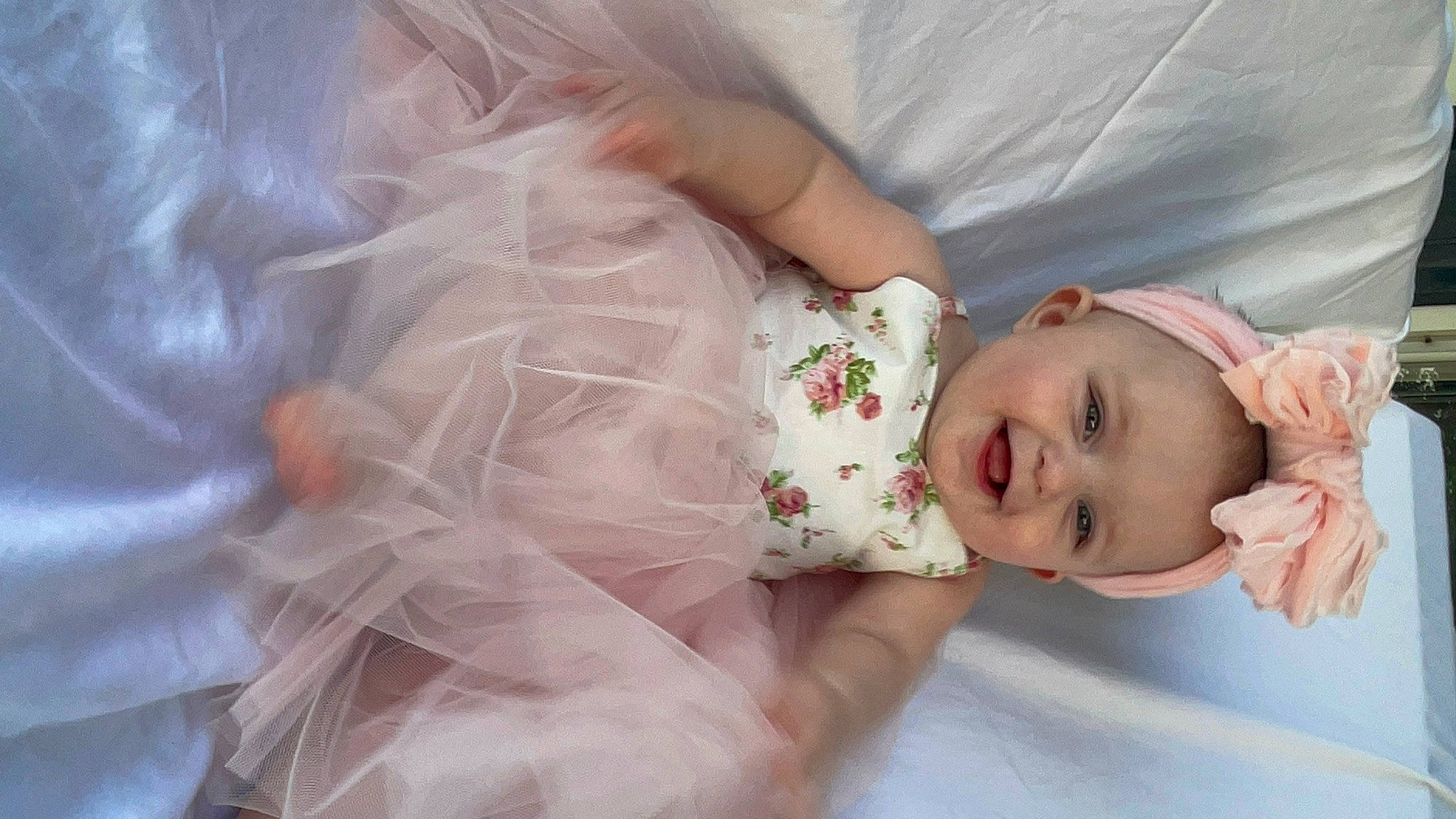 Freya is registered to the contest to win money with this photo: arm, baby, baby_toddler_clothing, cheek, clothing, comfort, dress, eye, eyelash, finger, hand, happy, head, headgear, iris, joy, lip, person, pink, skin