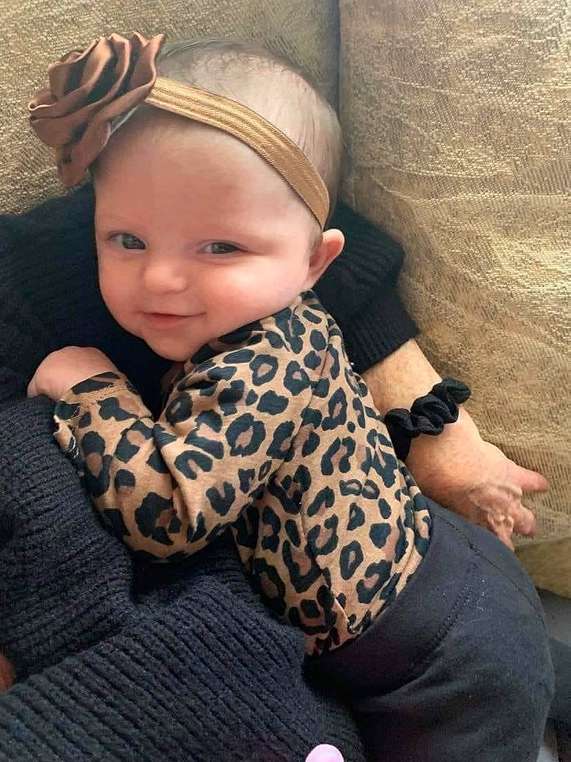 Freya is registered to the contest to win money with this photo: arm, baby_toddler_clothing, cap, clothing, comfort, cool, dress, face, fashion, head, leg, lip, neck, outerwear, person, skin, sleeve, textile, thigh, watch