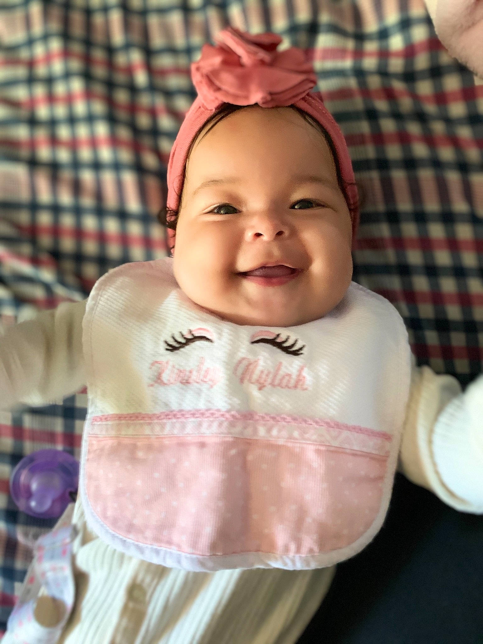Kinsley is registered to the contest to win money with this photo: baby, cheek, child, chin, doll, eye, eyebrow, forehead, happy, head, joy, lip, mouth, nose, person, pink, skin, smile, tartan, textile