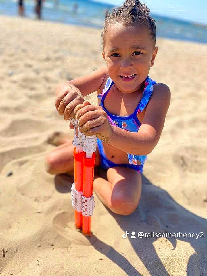 Arriahna joined the competition — help win amazing prizes! beach, body_of_water, child, electric_blue, fun, happy, human_leg, joy, people_in_nature, people_on_beach, person, photograph, plastic_bottle, recreation, sand, sky, smile, summer, thigh, toddler