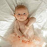 baby, infant, tutu, blanket, soft, cute, child, portrait, lying_down, skin, expression, newborn, adorable, clothing, tulle, person, indoors, sleepwear, resting, peaceful