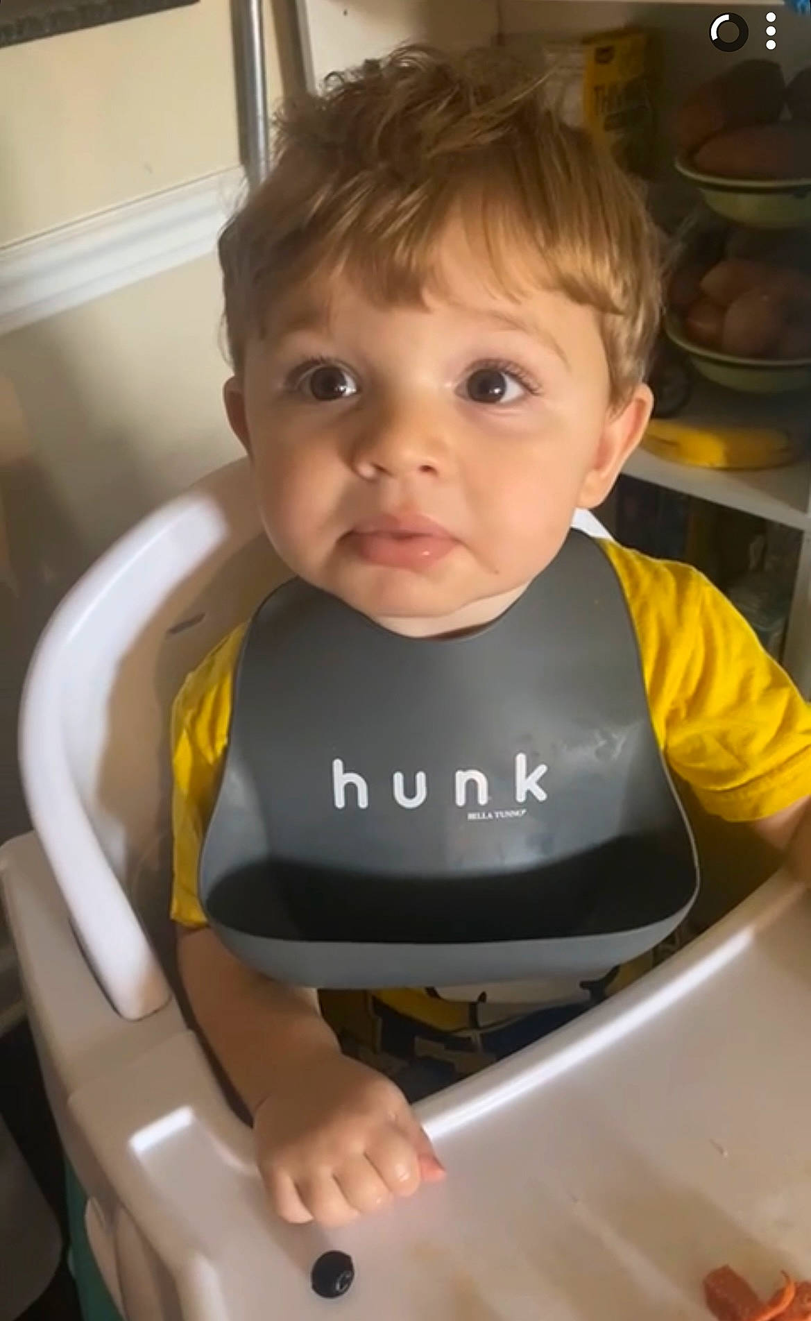 Raelan is registered to the contest to win money with this photo: auto_part, baby, baby_carriage, baby_products, baby_safety, baby_toddler_clothing, bib, cheek, child, chin, eyebrow, facial_expression, fun, hair, iris, person, personal_protective_equipment, sitting, sleeve, t_shirt